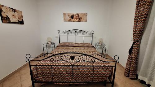 a bedroom with a bed and two night stands at Agriturismo Tre Cerri di Zanaboni Franca in Orbetello