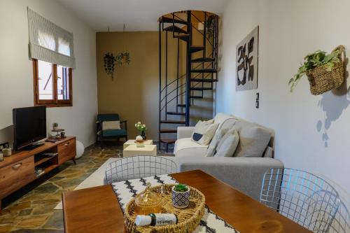 a living room with a couch and a table at almond home in Livadia