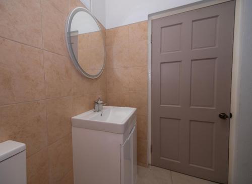 a bathroom with a white sink and a mirror at SOHI Villa in Gros Islet