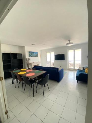 a living room with a table and a blue couch at Apartamento Vista Mar in Praia da Vieira