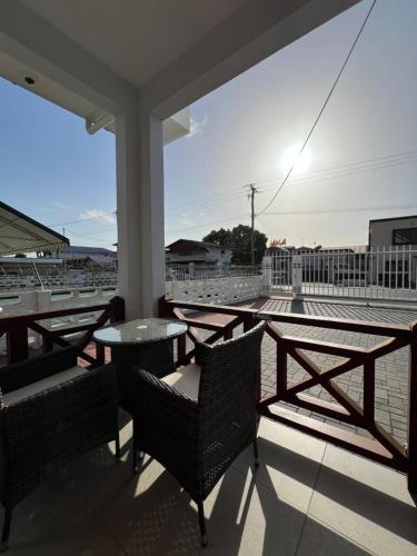a patio with chairs and a table on a roof at Snowy Lodge, fully airconditioned & luxurious apartments in Paramaribo