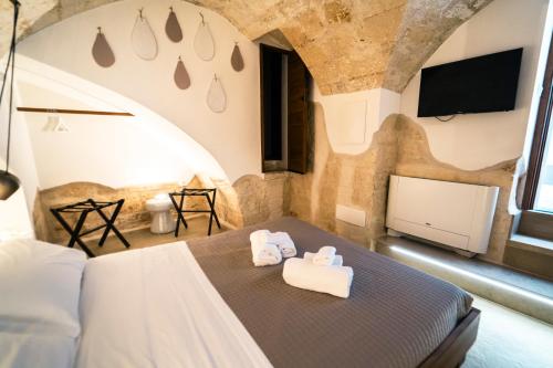a bedroom with a bed with two towels on it at Palazzo Fiscaiolo in Monopoli