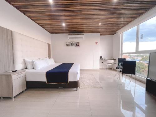 Katil atau katil-katil dalam bilik di Hotel Punta Arena Spa Boutique