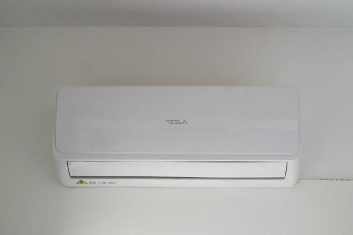 a white computer monitor sitting on top of a counter at Blue Sea Apartment in Adelianos Kampos