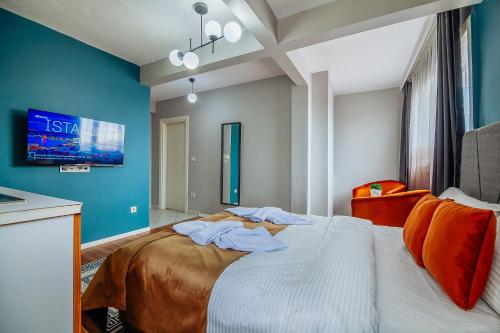 a bedroom with a large bed with blue walls at Taksim Wonder Suites in Istanbul