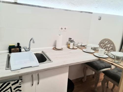a kitchen with a sink and a counter top at Loft con baño y cocina privados in San Sebastián de los Reyes