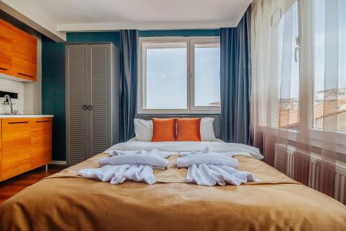 a bedroom with a large bed with orange pillows at Taksim Wonder Suites in Istanbul