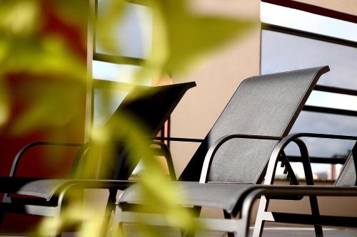 a group of chairs and a table with a plant at Hotel Germânia in Joinville