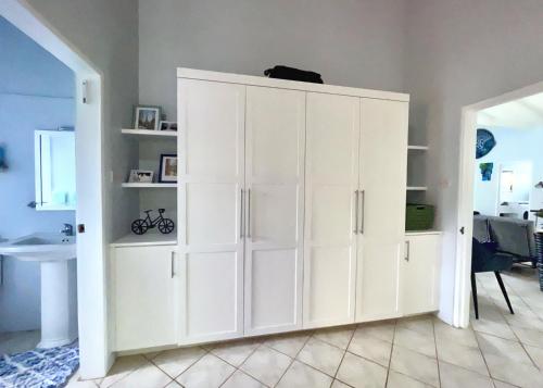 a large white cabinet in a living room at Villa Lu-Ja in Mount Cassell Land Settlement