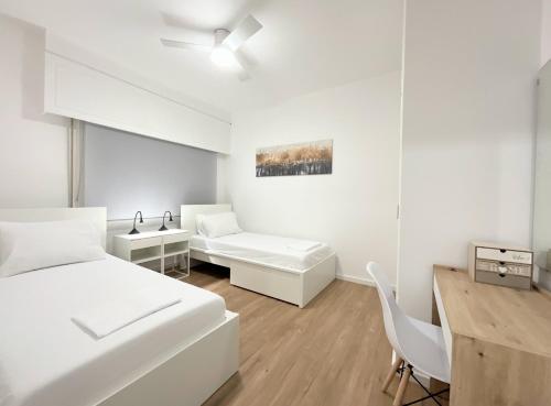 a white room with a bed and a desk at Appartment 300m from sea and lake in Larnaca