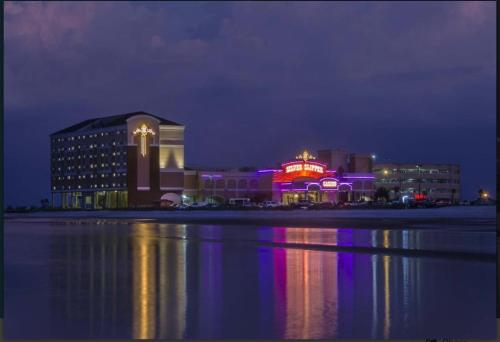 a building with a neon sign on it at night at Bay Breeze Bliss-Hot Tub, Bar and Canal 5mi to Beach in Shoreline Park