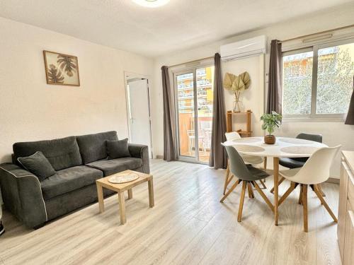 un salon avec un canapé et une table dans l'établissement Méditerranée, 2 pièces très calme, clime, centre ville, à Menton