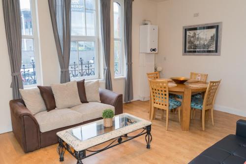a living room with a couch and a table at Aston Apartments-4 11 Lichfield Road Birmingham B6 5RW in Birmingham