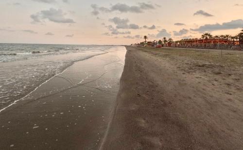 a view of the beach at sunset at Modern apartment near McKenzie beach in Larnaka