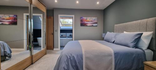 a bedroom with a large bed and a bathroom at Causeway Rooms in Ballybogy