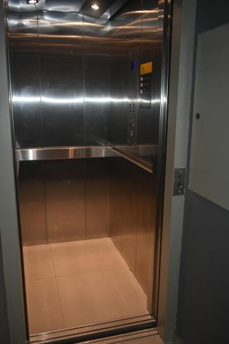 an empty elevator in a building with its door open at Unity Hotel - Paulista - SP in Sao Paulo