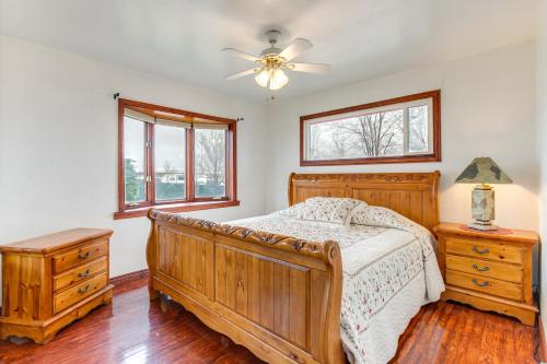 a bedroom with a wooden bed and a ceiling fan at Momos Place about 7 Mi to Colorado Convention Center! in Denver