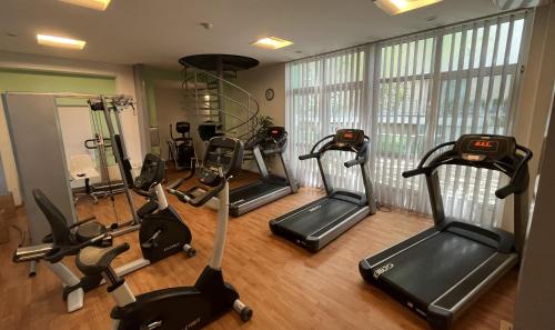 a gym with five exercise bikes in a room at Spa Residence Carbona 101, 307 Apartman in Hévíz