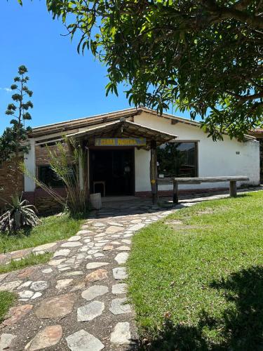 a building with a stone path in front of it at Pousada Serra Morena in Serra do Cipo