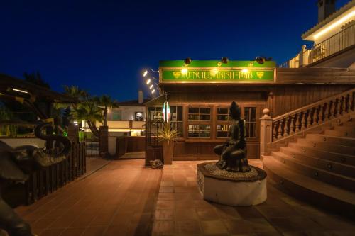 a building with a statue in front of it at night at Hotel Zen Airport in Torremolinos