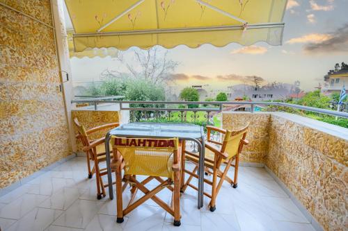 a table and chairs on a balcony with a view at Iliahtida Apartments in Rovies