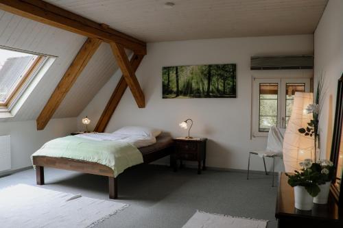 a bedroom with a bed in a attic at Mooshof Apartment in Münchenbuchsee