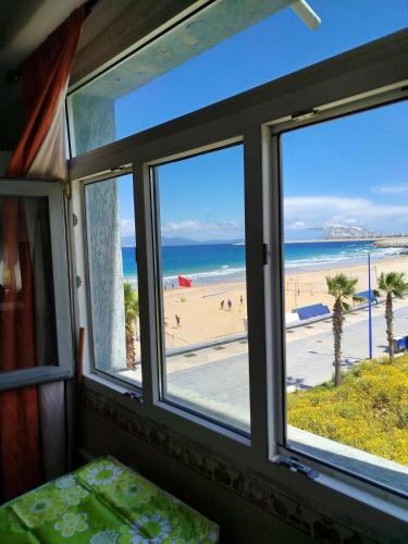 a room with a window with a view of the beach at Apartment Corniche Ksar Sgher in Ksar es Sghir