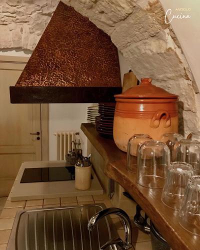 a kitchen with a sink and a pot on a counter at Trullo Galileo in Alberobello