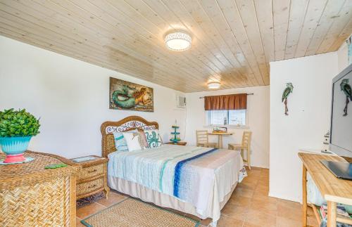 a bedroom with a bed and a desk and a television at Hernando Beach Home on Dolphin Cove Dock and Kayaks in Hernando Beach