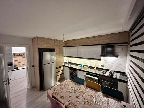 a kitchen with a stove and a refrigerator at Kırevi-Airport in Ortaca