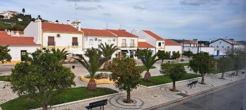 a row of houses with palm trees in a town at Alojamento Cabeço de Vide in Cabeço de Vide