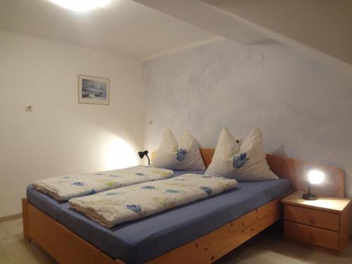 a bedroom with a bed with pillows on it at Frühstückspension Doris Eder in Gaming