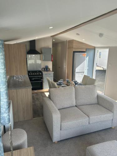a living room with a couch and a kitchen at Secluded spot on Southview 8 berth in Lincolnshire