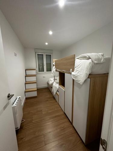 a small room with a bunk bed and a staircase at O LAR DE DON BASILIO in Redondela