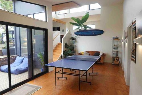 a living room with a table and a couch at Beachside Family Surf Retreat in Carlton