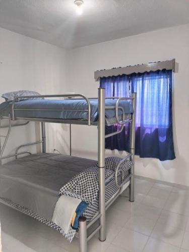 a room with two bunk beds and a window at Casa Villas del Manantial in Durango