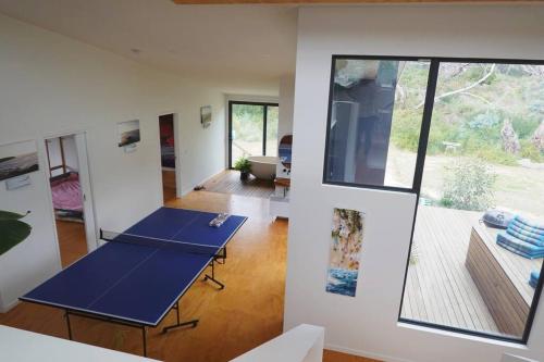 a room with two ping pong tables in it at Beachside Family Surf Retreat in Carlton