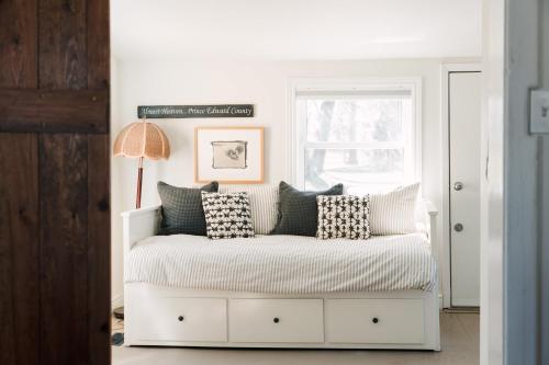 a white bed with pillows on it in a room at County Escape on Corey in Bloomfield