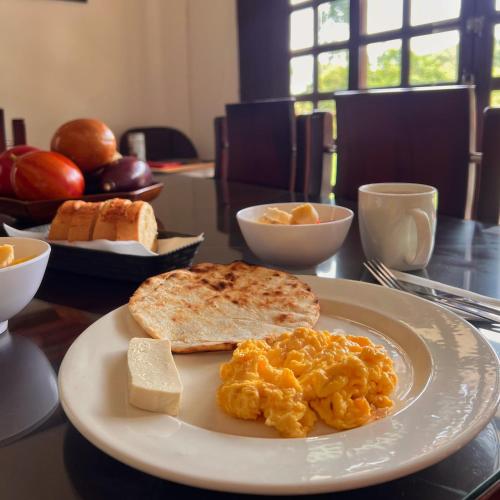 a plate of food with eggs and toast on a table at Paraiso Cocora in Salento