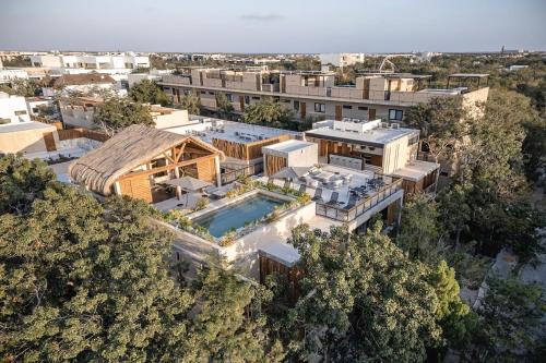 an aerial view of a house with a swimming pool at Premium Apartment in Tulum 2 Bedrooms Roof Top Pool - Aldea Zama in Tulum