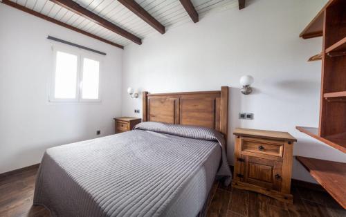 - une chambre avec un lit doté d'une tête de lit en bois et d'une fenêtre dans l'établissement House in Tarifa beach in Valdevaqueros, à Tarifa