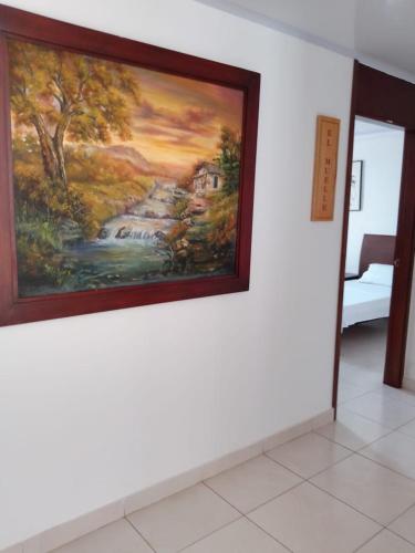a painting hanging on a wall in a room at Edificio Tony - Alojamiento Aparta-Hotel in Barrancabermeja