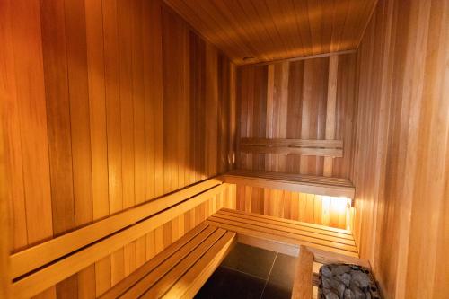 an empty wooden sauna with a bench in it at Eichardt's Private Hotel in Queenstown