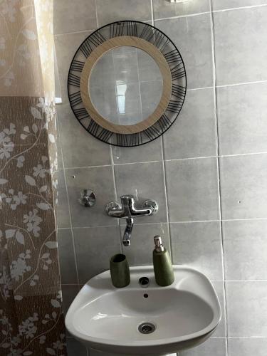 a bathroom with a sink and a mirror at Sunset apartment in Tivat