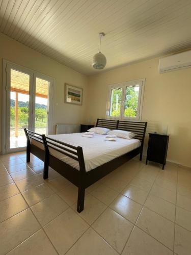 a bedroom with a large bed in a room at Thalassa Hideaway in Dhiminión