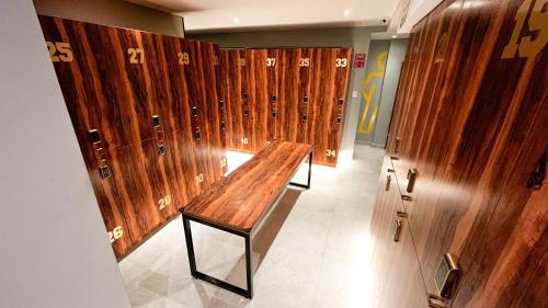 a row of wooden lockers in a room at The Yellow Capsule Hotel Close to Airport in Cancún