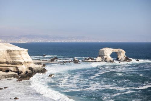 a view of the ocean with an arch in the water at Holiday Inn Express - Antofagasta by IHG in Antofagasta