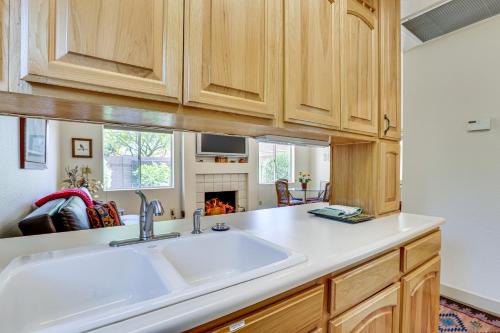 a kitchen with a sink and a fireplace at Patio and Pool Access Sunny Phoenix Casita! in Phoenix