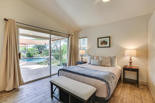 a bedroom with a bed and a sliding glass door at Patio and Pool Access Sunny Phoenix Casita! in Phoenix