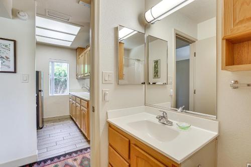a bathroom with a sink and a mirror at Patio and Pool Access Sunny Phoenix Casita! in Phoenix